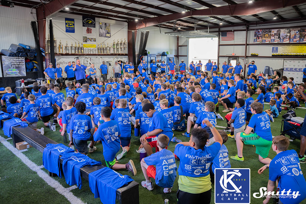 Kansas City Youth Football Camp Host Jim Tuso talking to youth football players inside Kansas City Athlete Training Sports Performance Facility and Football Academy in Kansas City Missouri